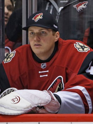 Coyotes' Nathan Schoenfeld sits on the bench after only being signed a couple hours before to play backup for Coyotes' goalie Louis Domingue after an injury to Anders Lindback at Gila River Arena in Glendale, Ariz., on Monday, February 15, 2016.