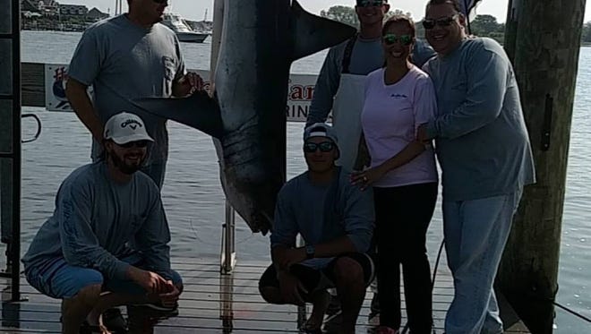 The crew of the TraSea Ann, poses with the winning mako shark during the Brett T. Bailey Mako Rodeo held at Hoffman's Marina in Brielle.