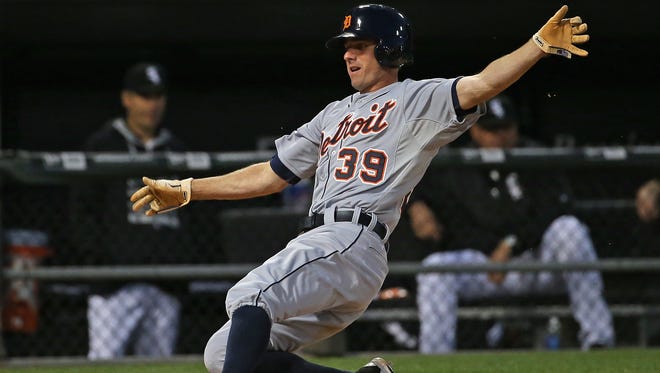 Tigers third baseman Josh Wilson slides in to score a run in the 7th inning of the Tigers' 7-1 win Saturday in Chicago.
