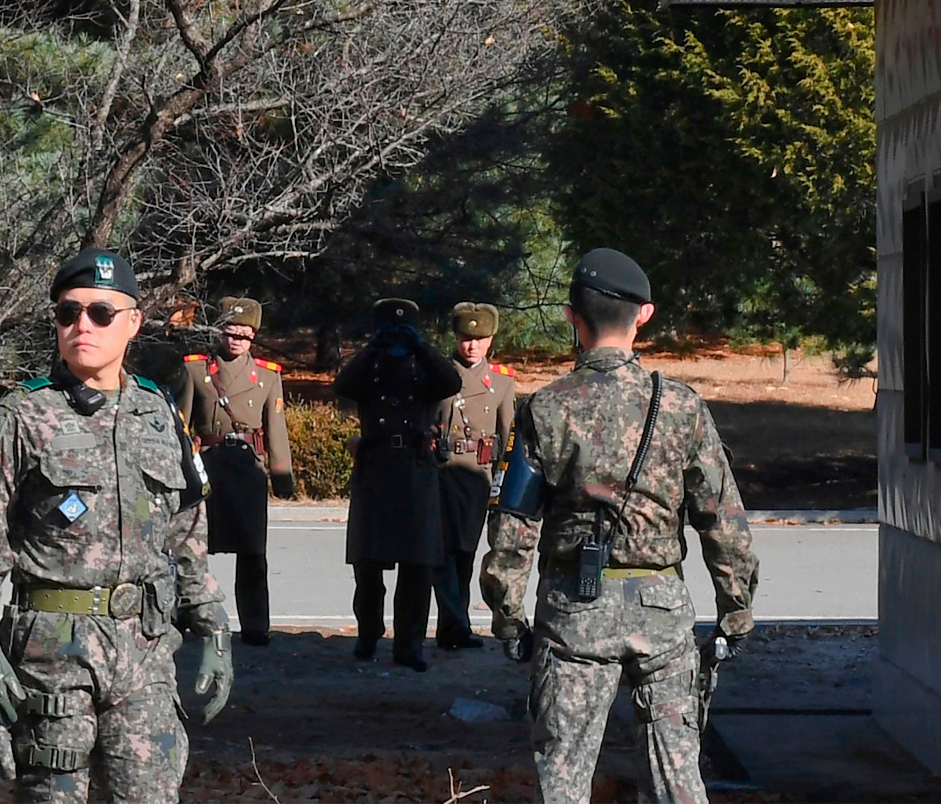 North Korean soldiers stare at South Korean soldiers at the truce village of Panmunjom in the Demilitarized Zone dividing the two Koreas on Nov. 27, 2017.