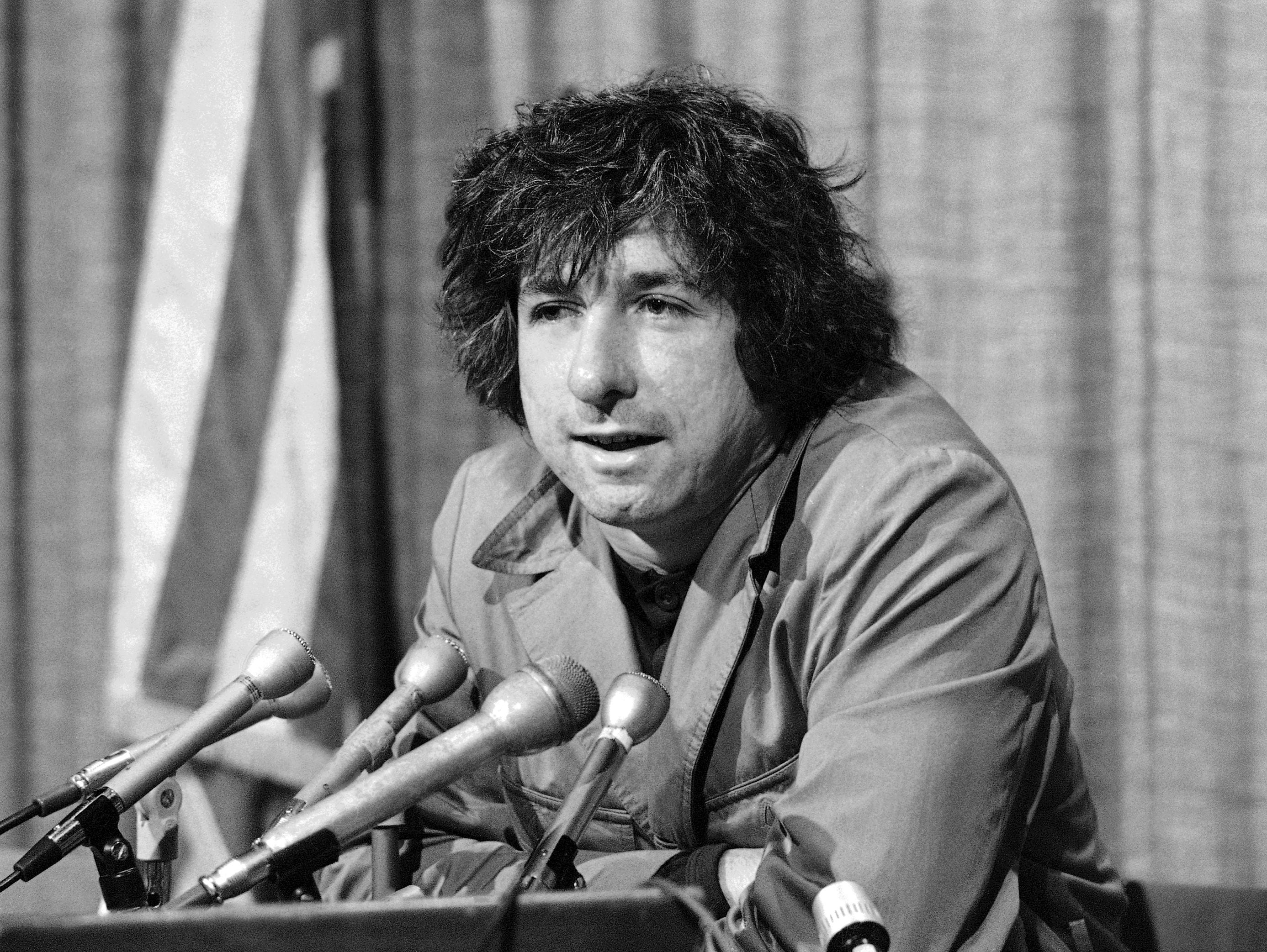 In this Dec. 6, 1973 file photo, political activist Tom Hayden tells newsmen in Los Angeles that he believes public support was partially responsible for the decision not to send him and others of the Chicago 7 to jail for contempt. Hayden, the famed