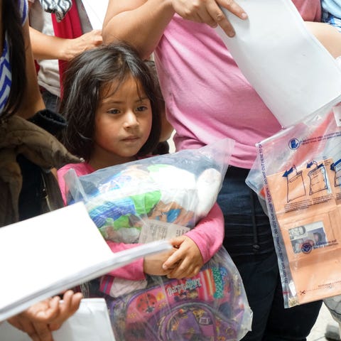 Surrounded by adults discussing their next steps,...