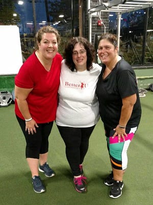 Allison Morris (center) is participating in this year’s BetterU Challenge. She’s working out with Gold’s Gym trainers and past BetterU participant mentors.