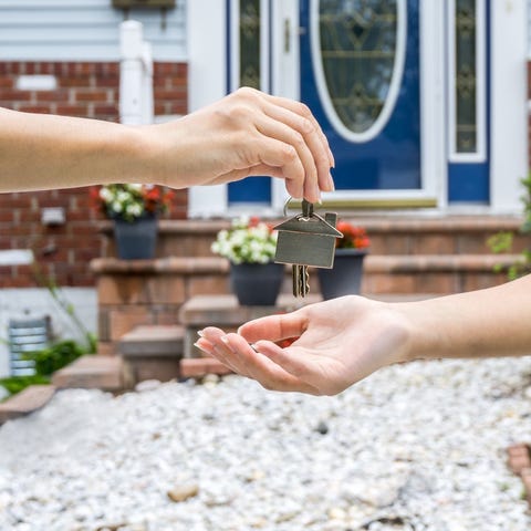 Homebuyers hands excepting keys to a new home.