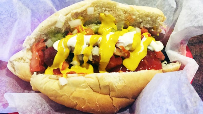 Mexican-style dog from Andele's Dog House: a bacon-wrapped hot dog, pinto beans, grilled onions, diced onions and tomatoes, and jalapeño mayonnaise, mustard, ketchup, jalapeño salsa, for $6.30.