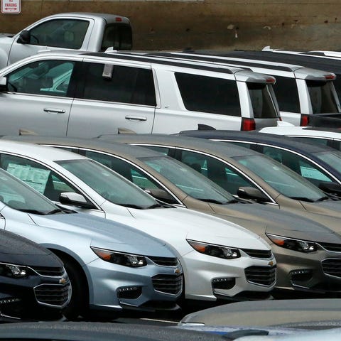 Chevrolet cars sit on a dealer lot.