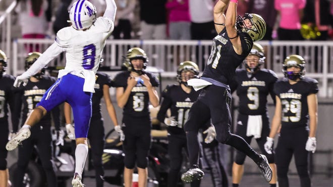 Andover Central's Kyle Kohman catches a pass against rival Andover at Jaguar Stadium on Friday, Oct. 16 in Andover, Kansas. The Jaguars took home the old school 7-0 win.