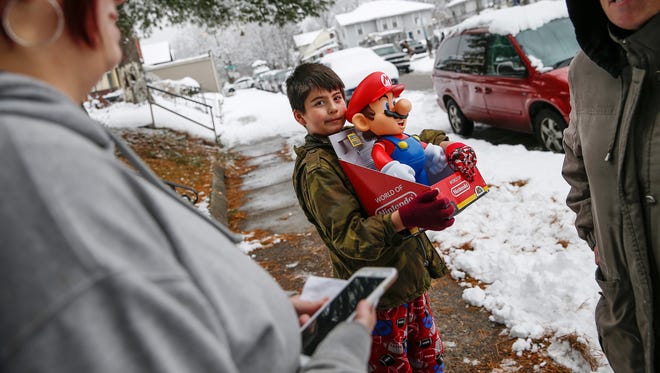 Luis Ortiz, 8, admires a new toy given to him by Santa during the IMPD Community Engagement Office's "Operation New Normal" sweep on Tuesday, Dec. 13, 2016. According to IMPD the objective is to promote public safety and crime prevention through quality of life enhancement.