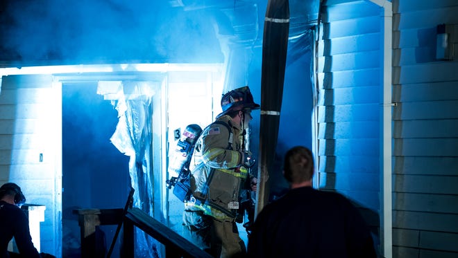 Firefighters work at the scene of a first-alarm residential fire in a vacant house to the rear of 808 York Street, Friday, April 6, 2018 in Penn Township. The fire, which was mostly limited to a room and contents fire, is currently under investigation, said Hanover Area Fire Rescue Chief Tony Clousher.