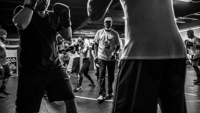 "Bring it before you shoot it," said Sugar Ray Seales, middle, while training boxing students at Indy Boxing and Grappling, on Wednesday, April 4, 2018. "Way to work, way to work, way to work. That's right. Nice jab, now come get it. Step on it. That's that jab. That's that jab. Good."