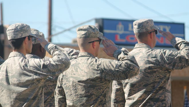 In this file photo, airmen from Holloman Air Force Base salute during the 2015 Veterans Day parade. This year's parade begins at 10 a.m.