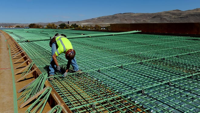 A construction worker works on the Southeast Connector's first phase in 2013. The project is funded by a gas tax revenue boosted through a ballot question approved by Washoe County voters in 2008.