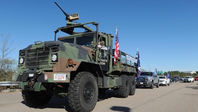 Adam Lange drives an Army truck that he has used to lead Trump rallies on Cape Cod.