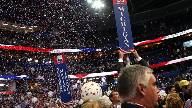 National political conventions are like pep rallies. In 2012, a person removes the sign for the Michigan delegation after Republican presidential candidate, former Massachusetts Gov. Mitt Romney accepted the nomination during the final day of the Republican National Convention.