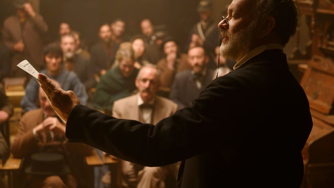 Jefferson Kyle Kidd (Tom Hanks) lets townsfolk all over Texas know what's going on.
