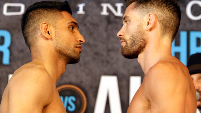 Boxers Amir Khan, left and Chris Algieri pose during their weigh-in Thursday. (Photo: Mary Altaffer, AP)