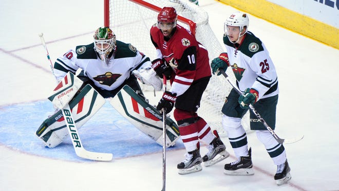 Oct. 15, 2015; Glendale; Arizona Coyotes left wing Anthony Duclair (10) sets up in front of Minnesota Wild goalie Devan Dubnyk (40) as defenseman Jonas Brodin (25) defends during the first period at Gila River Arena.