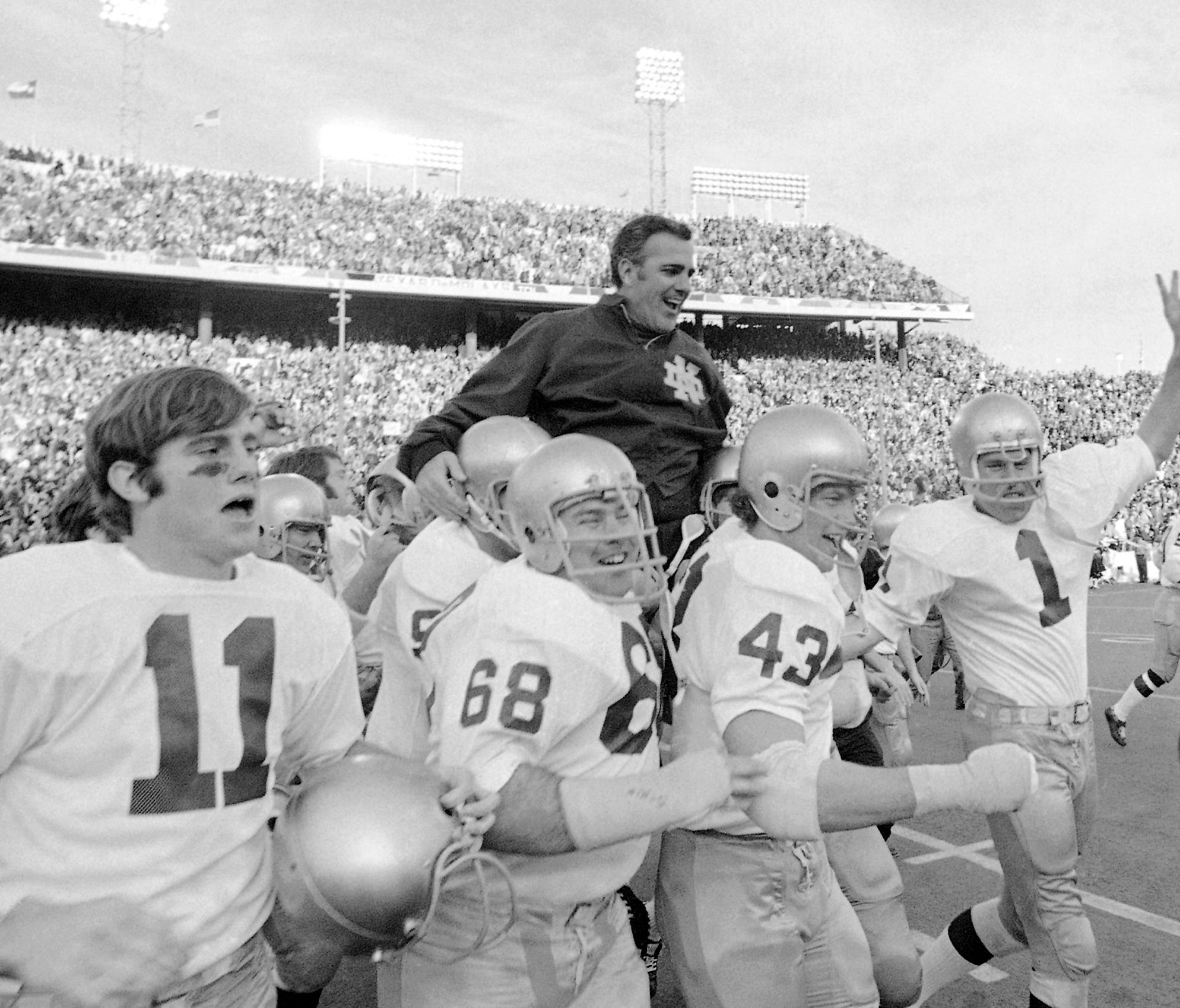FILE - In this Jan. 1, 1971, file photo, Notre Dame coach Ara Parseghian is carried off the field by his victorious players after the Irish victory over Texas 24-11 in the Cotton Bowl NCAA college football game in Dallas. At a time when college footb
