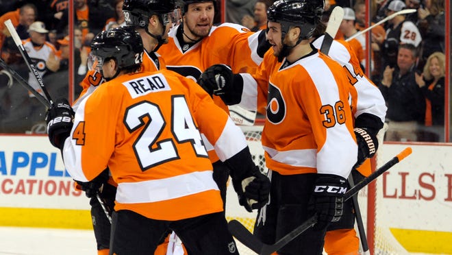 
Flyers center Zac Rinaldo (36) celebrates his goal with right wing Matt Read (24), defenseman Mark Streit (32) and defenseman Nicklas Grossmann (8) against the Buffalo Sabres during the second period at Wells Fargo Center on Sunday.
