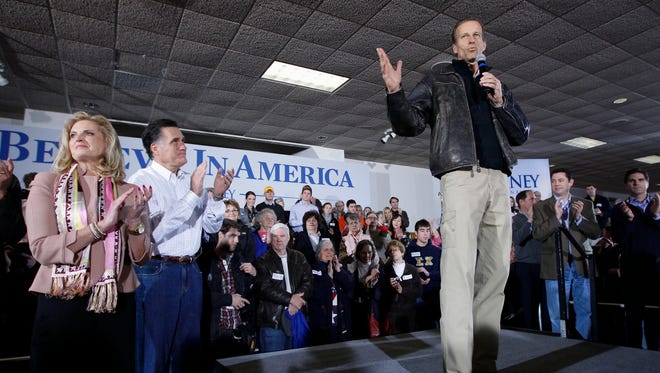 Sen. John Thune (right), R-S.D.,  is shown stumping for 2012 Republican presidential candidate, former Massachusetts Gov. Mitt Romney, during a campaign event at Davenport, Iowa, on Jan. 2, 2012. Romney's wife Ann is at left.