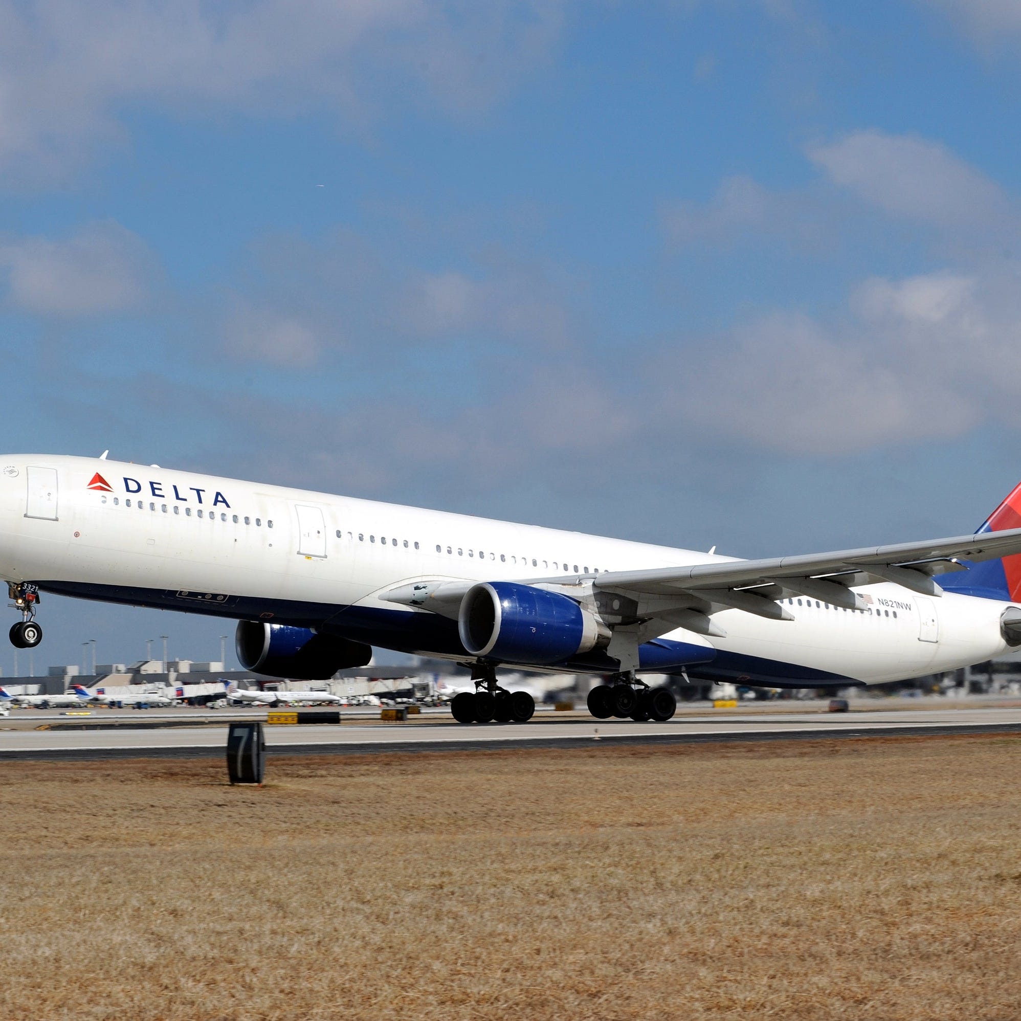 A Delta Air Lines plane landing on a runway.
