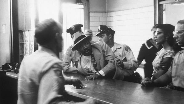 Atlanta police arrest Martin Luther King Jr. and students who took part in sit-in in downtown Atlanta on Oct. 19, 1960.