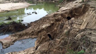 Raw sewage pours from a broken pipe into Loosahatchie in April. The pipe ruptured when the river bank washed out in heavy rain. (Tom Charlier/The Commercial Appeal)
