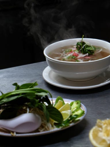 Pho sits steaming on the counter at Pho Tai. The beef