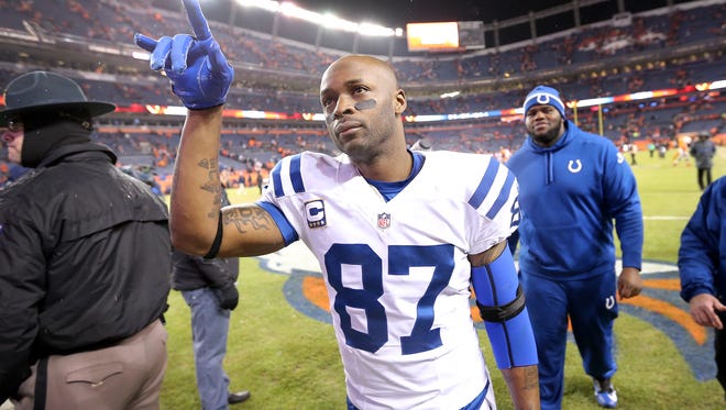 Indianapolis Colts wide receiver Reggie Wayne waves to fans after a win over the Broncos, 24-13. Indianapolis faced Denver in the NFL playoffs Sunday, January 11, 2015.