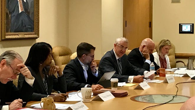 University of Tennessee President Joe DiPietro, second from right, listens as Chief Financial Officer David Miller, third from right, gives an update on the university's projected budget gap to members of the board of trustees and Budget Advisory Group at Andy Holt Tower on the UT Knoxville campus on Thursday, May 25, 2017.