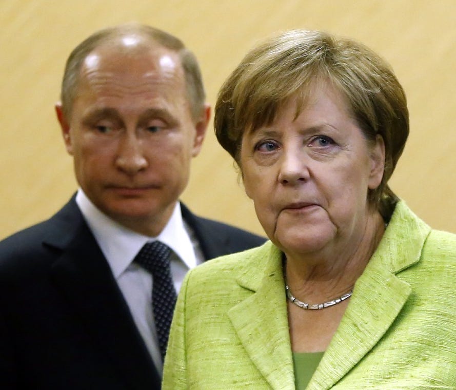 Russian President Vladimir Putin, left, and German Chancellor Angela Merkel walk to a press conference in the Black Sea resort of Sochi, Russia, on May 2.