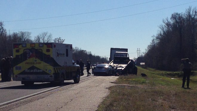 Law enforcement works at the scene of a fatal crash on U.S. Highway 165 on Thursday afternoon. One person died in the crash, which started when Rapides Parish Sheriff's deputies tried to serve an arrest warrant.