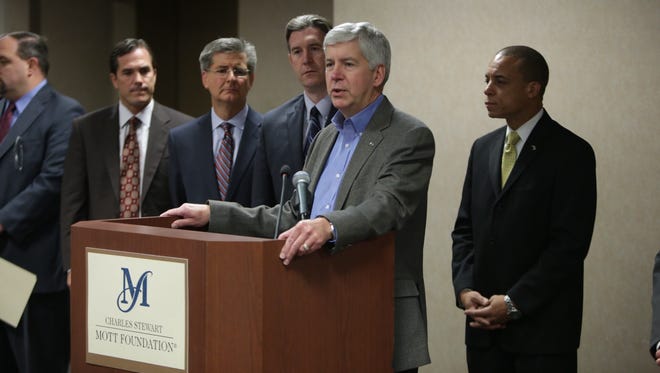 Gov. Rick Snyder makes an announcement to switch the Flint water system back to Detroit during a news conference on Thursday, Oct. 8, 2015 at the Mott Foundation/Commerce Center Building in downtown Flint.