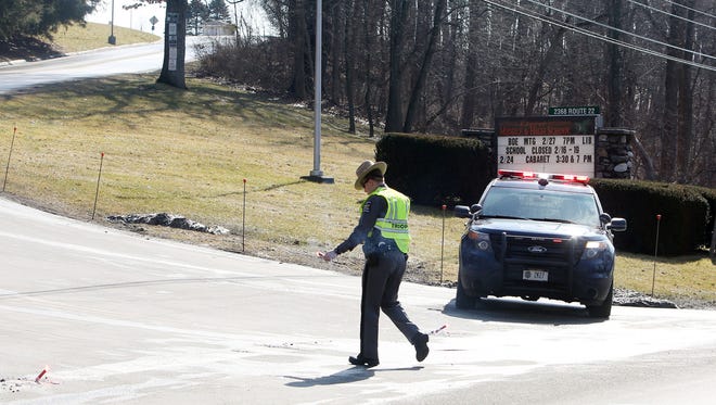 A state trooper blocks the entrance to Dover High School on Route 22 after a threat was made against the Dover schools on Wednesday.