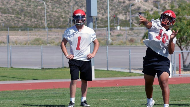 Quarterbacks Lance Frost (left) and Noah Bartlett (right) practice their throwing skills during Centennial High's first day of fall practice on Monday afternoon.