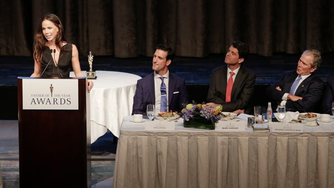 Barbara Bush, daughter of former President George W. Bush, right, speaks about her father as Mark Shriver, second from right, and Dan Orwig, second from left, listen, during the  74th Annual Father of the Year Awards benefit luncheon Thursday, June 18, 2015, in New York.