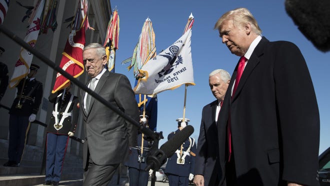 President Donald Trump, joined by Defense Secretary Jim Mattis, left, and Vice President Mike Pence, walks into the Pentagon, Thursday, Jan. 18, 2018, after speaking to the media. (AP Photo/Carolyn Kaster)