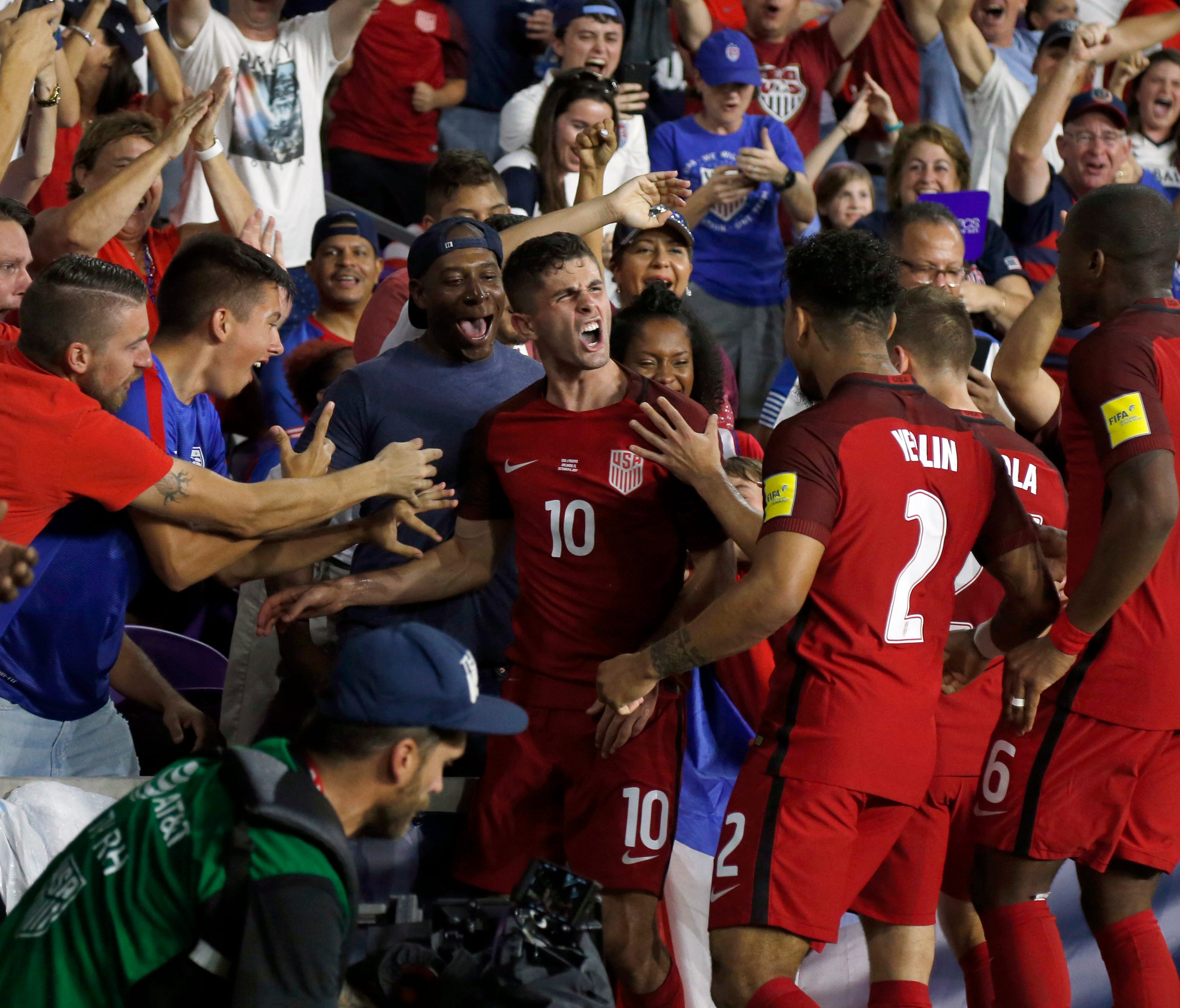 USMNT star Christian Pulisic (10) celebrates with teammates and fans after he scored a goal in a World Cup qualifying match on Friday night.