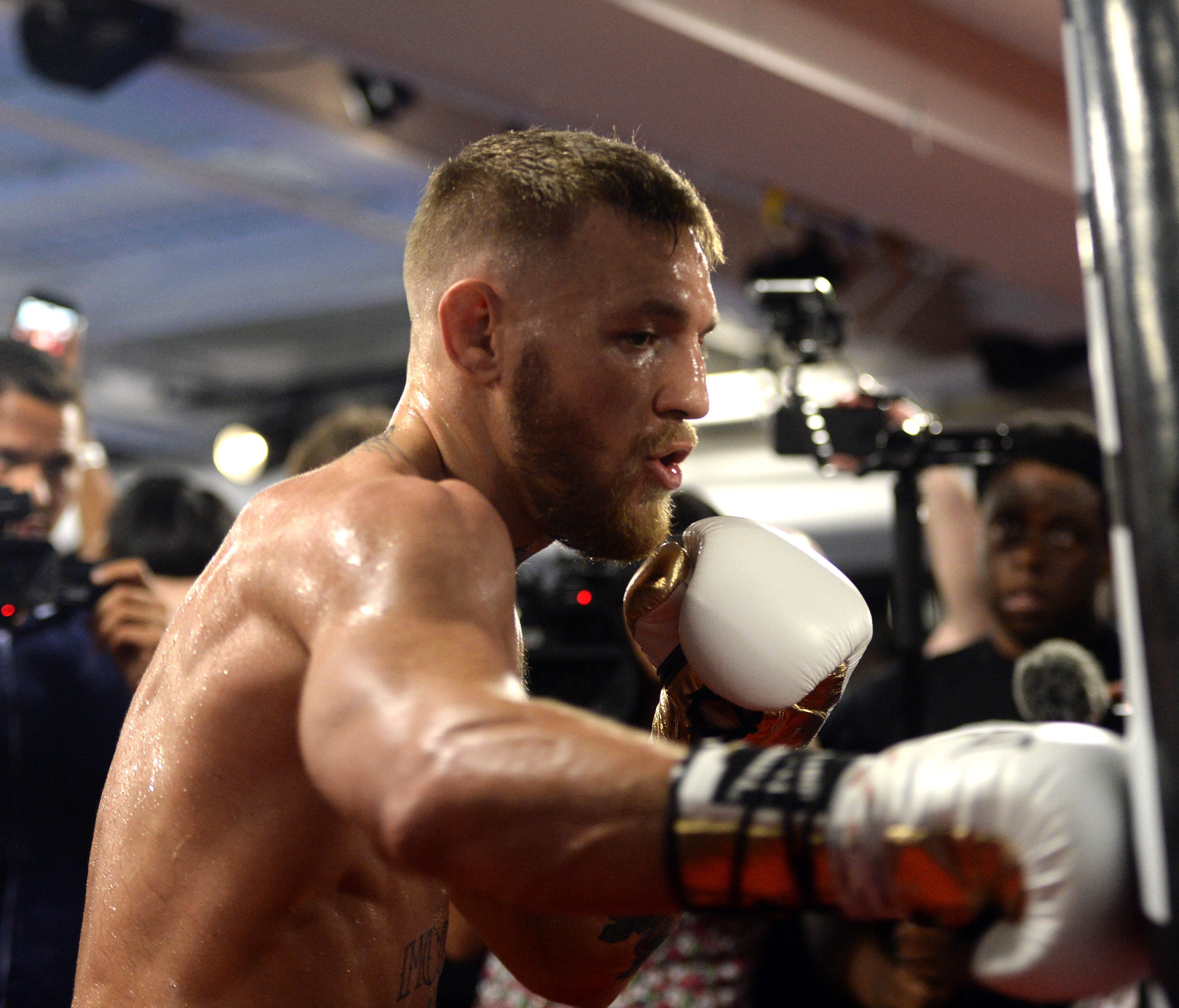 Conor McGregor hits a heavy bag during a media workout in preparation for his fight against Floyd Mayweather, Jr. at UFC Performance Institute.