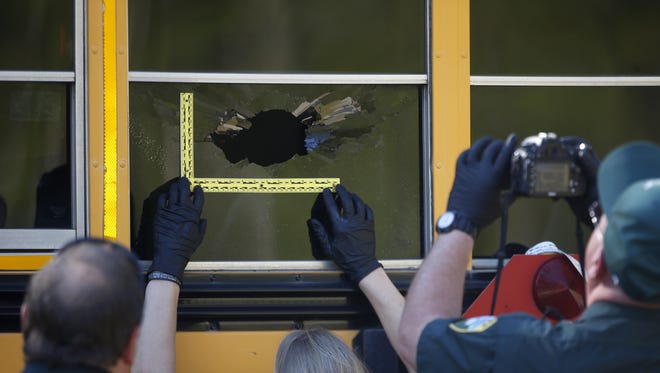 The Leon County Sheriff's Department inspects a bus at Killearn Lakes Elementary School where, what is suspected to be, an ammunition round broke the glass on a school bus window as children were boarding after school on Tuesday, March 22, 2016.