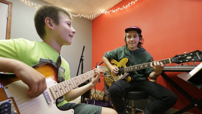 Harper West, left, takes an electric guitar lesson from instructor Marcus Wittmann at  Kurt Stein's School of Music in Neenah.