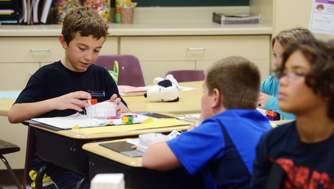 Camryn Richarz works on calculating the area of a rectangle in his 5th grade math class at R. F. Pettigrew Elementary School Tuesday, Nov 17, 2015.