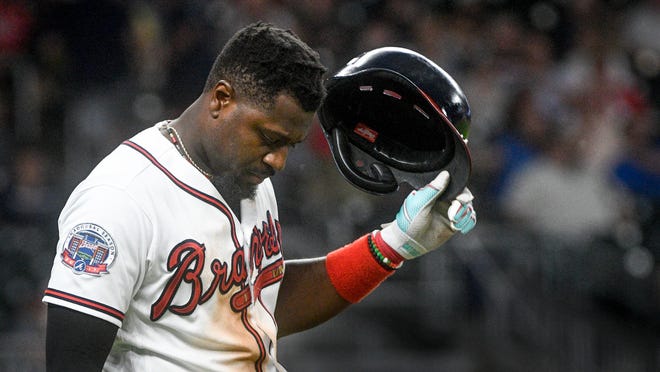 Atlanta Braves' Brandon Phillips takes off his batting helmut and prepares to take the field after getting out with a line fly to center field to end the eighth inning of a baseball game against the Philadelphia Phillies, Tuesday, June 6, 2017, in Atlanta. Philadelphia won 3-1. (AP Photo/John Amis)
