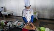 A chef prepares a dish during a demonstration at the