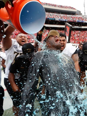 Vanderbilt coach Derek Mason gets soaked by his payers after defeating Georgia 17-16 on  Oct. 15, 2016.