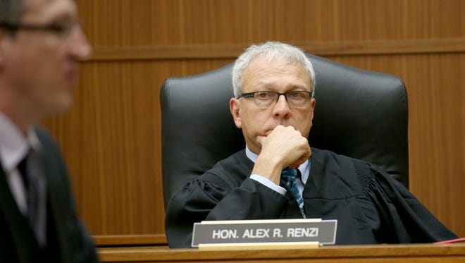 Judge Alex Renzi listens to attorney Christian Kennedy describe a robbery of drugs that's believed to have led to the kidnapping of the two students. Kennedy says his client, Lydell Strickland, had nothing to do with that crime.