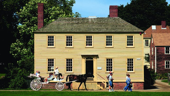 A carriage goes by the Lowd House at Strawbery Banke in Portsmouth. The museum announced it was temporarily closing on July 29 because a staff member has been exposed to a person who tested positive for COVID-19.