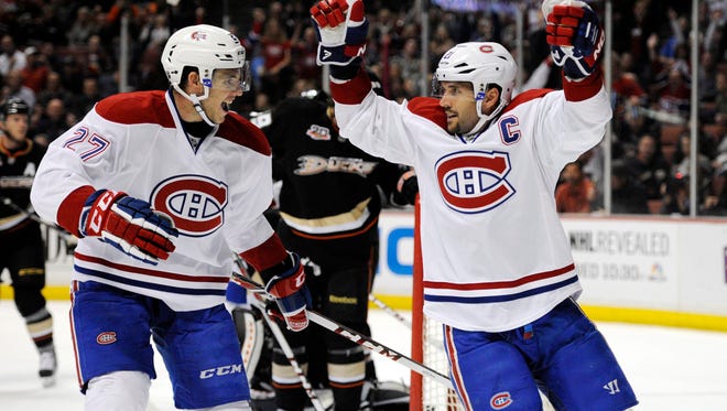 Greece native Brian Gionta, right, celebrates after scoring a goal for the Montreal Canadiens earlier this year. Gionta becomes a free agent on Tuesday.
