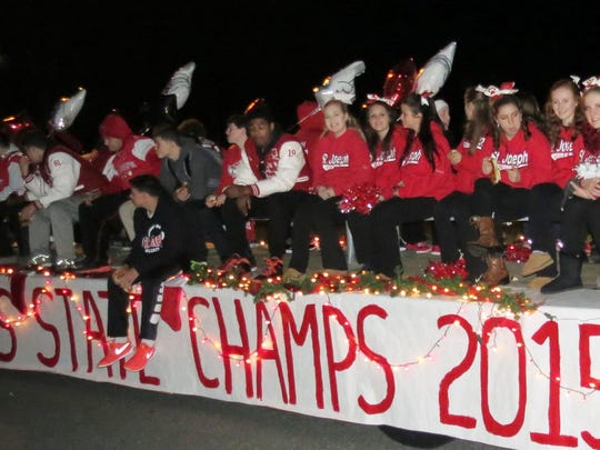 St. Joseph High School’s 2015 championship football team share their spirit during the parade on Saturday.