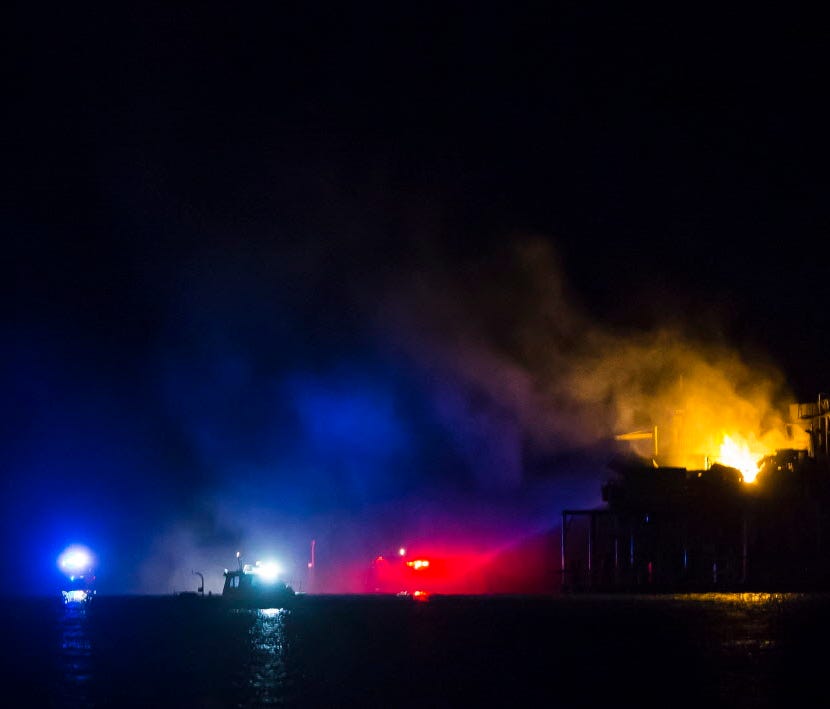 Rescue boats surround a rig in Lake Pontchartrain near New Orleans after the rig exploded late on Oct. 15, 2017.
